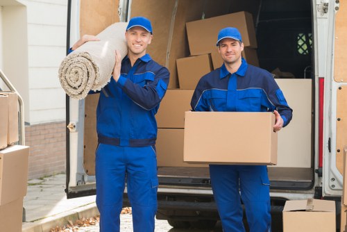 Local movers handling furniture in a Camden flat