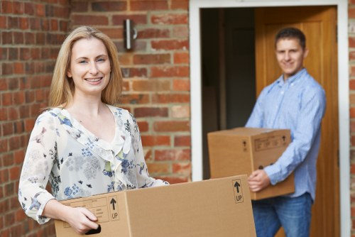 Movers navigating stairs in a Camden residential building