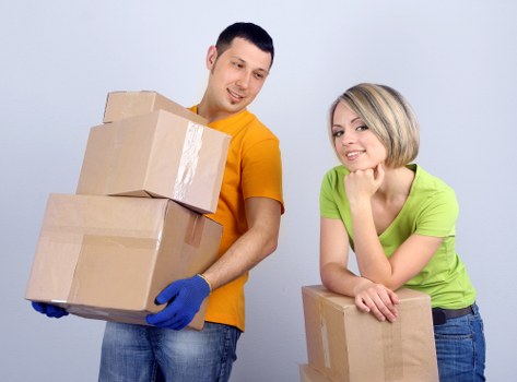 Packed moving boxes and furniture in a Camden flat