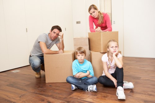 Labelled moving boxes and furniture for a Camden home relocation